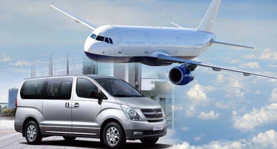 Luton Airport taxi transfer service with a spacious minivan and an airplane in the background